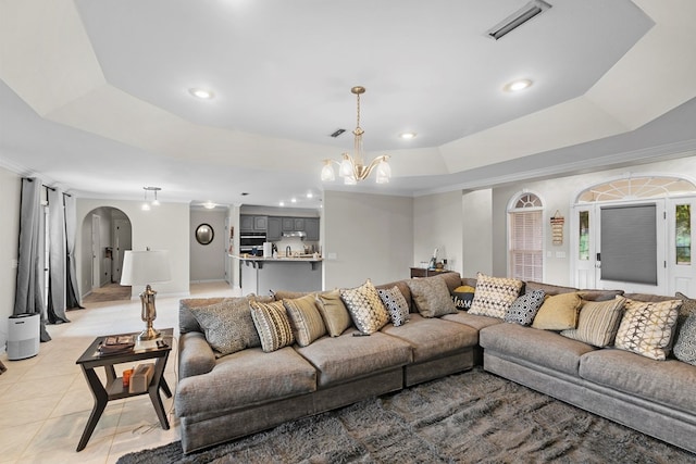 6 Piedmont Pl, Enterprise, AL 36330 - living room featuring a tray ceiling, arched walkways, a chandelier, light tile patterned floors, and recessed lighting