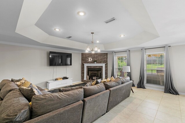 6 Piedmont Pl, Enterprise, AL 36330 - living room featuring a tray ceiling, light tile patterned floors, a large fireplace, recessed lighting, and crown molding