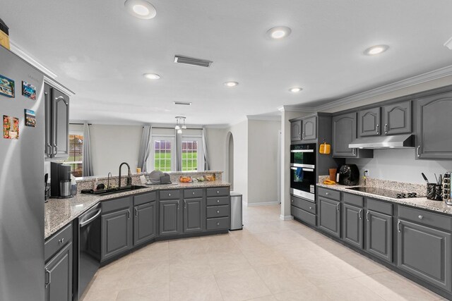 6 Piedmont Pl, Enterprise, AL 36330 - kitchen with stainless steel appliances, under cabinet range hood, a peninsula, crown molding, and arched walkways