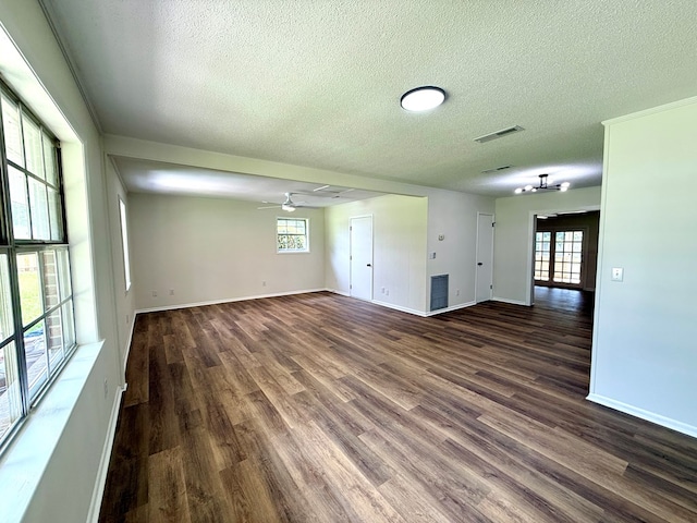 143 Durby Ln, Dothan, AL 36305 - unfurnished living room featuring a textured ceiling, dark wood-style flooring, and a ceiling fan