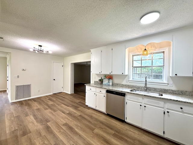 143 Durby Ln, Dothan, AL 36305 - kitchen featuring stainless steel dishwasher, a textured ceiling, white cabinetry, wood finished floors, and light stone counters