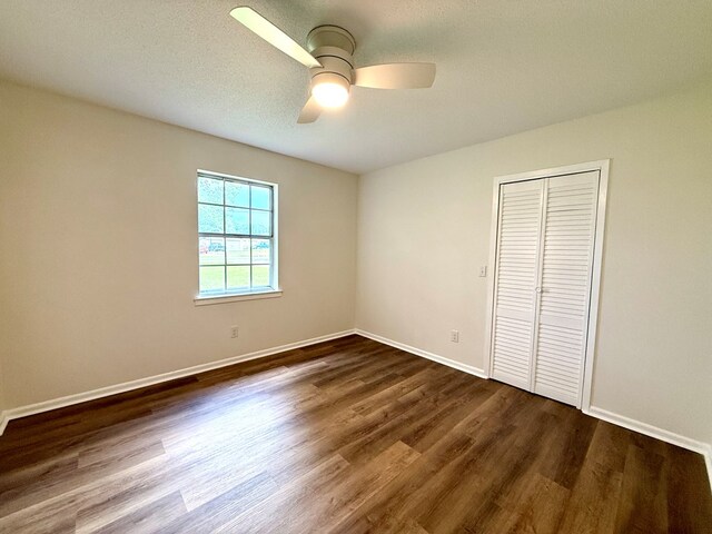 143 Durby Ln, Dothan, AL 36305 - unfurnished bedroom featuring dark wood-type flooring, a closet, and ceiling fan