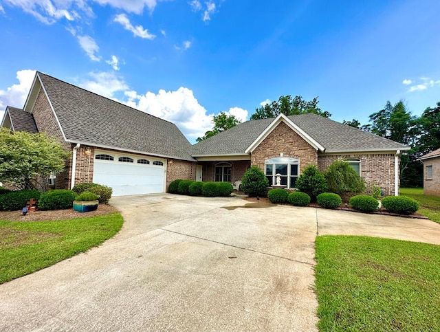 view of front of home featuring a front yard and a garage