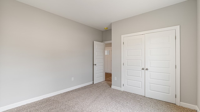 330 Heritage Way, Headland, AL 36345 - unfurnished bedroom with light carpet, baseboards, and a closet