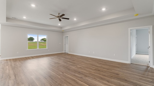 330 Heritage Way, Headland, AL 36345 - empty room featuring baseboards, visible vents, wood finished floors, a tray ceiling, and recessed lighting