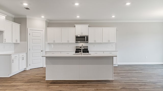 330 Heritage Way, Headland, AL 36345 - kitchen featuring a sink, wood finished floors, visible vents, appliances with stainless steel finishes, and a center island with sink