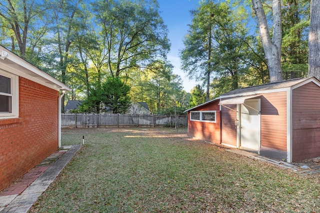 view of yard with fence and an outbuilding