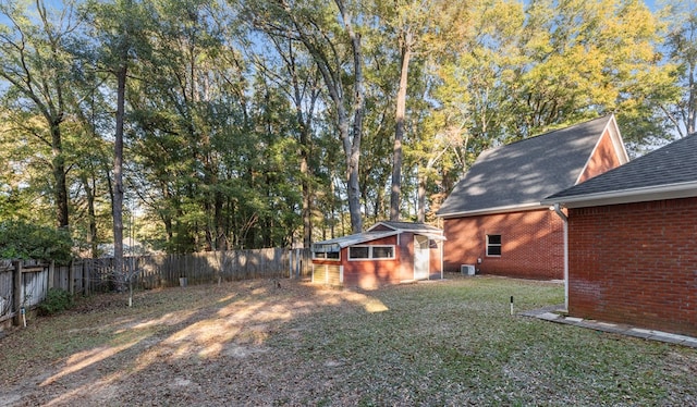 view of yard with a fenced backyard and an outbuilding