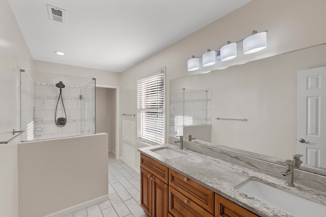 bathroom featuring visible vents, a sink, walk in shower, and double vanity