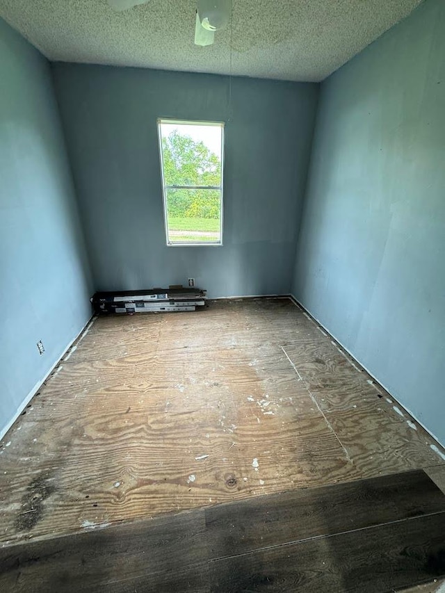 unfurnished room with a textured ceiling