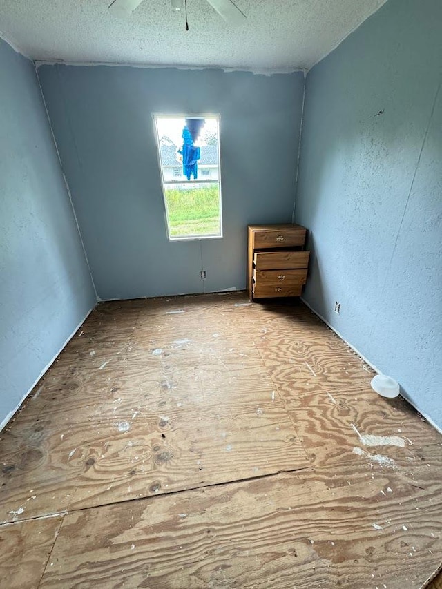 unfurnished room with a textured ceiling