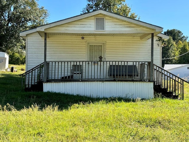 rear view of property with covered porch