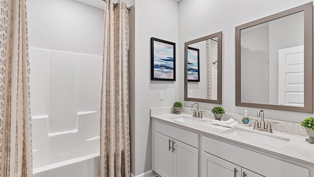 bathroom featuring vanity and shower / bathtub combination with curtain