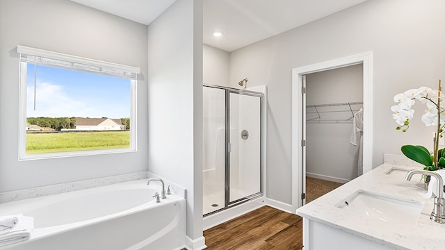 bathroom with plenty of natural light, separate shower and tub, and wood-type flooring