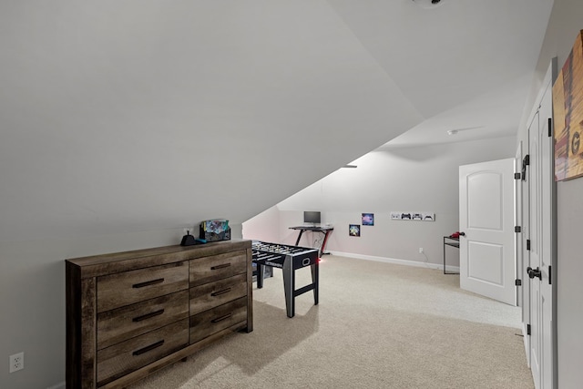 interior space with light colored carpet and vaulted ceiling