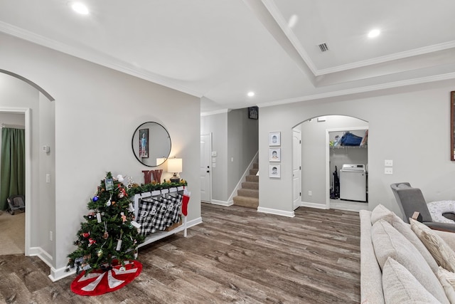 interior space with washer / dryer, dark hardwood / wood-style floors, and crown molding