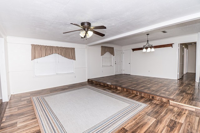 unfurnished room with visible vents, a textured ceiling, wood finished floors, and ceiling fan with notable chandelier