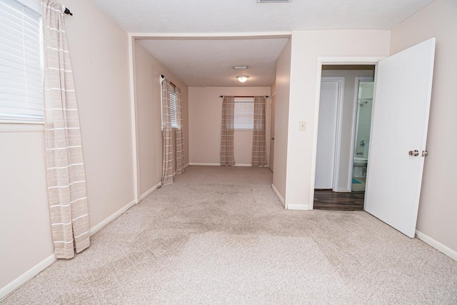 interior space with visible vents, baseboards, and carpet