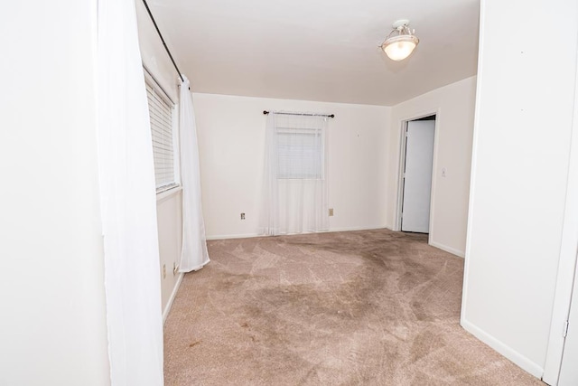 unfurnished bedroom with baseboards and carpet floors