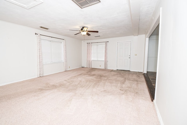 unfurnished room featuring carpet flooring, baseboards, visible vents, and ceiling fan
