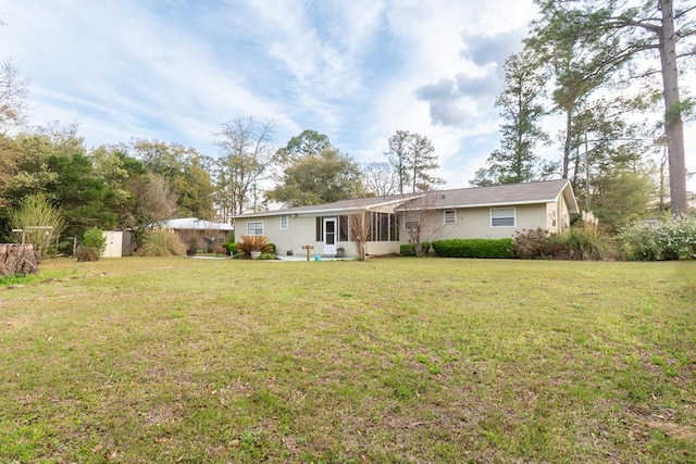 rear view of property featuring a yard