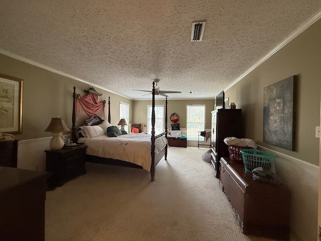 bedroom with ornamental molding, ceiling fan, and carpet flooring