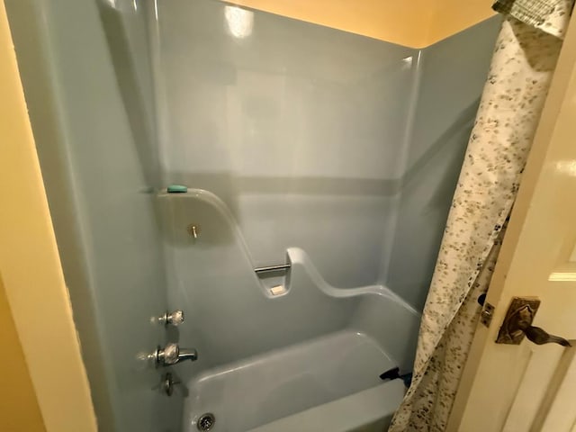 bathroom with bathing tub / shower combination