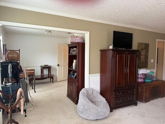 bedroom with crown molding, light colored carpet, and a textured ceiling