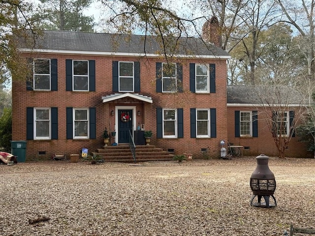 colonial inspired home featuring a fire pit