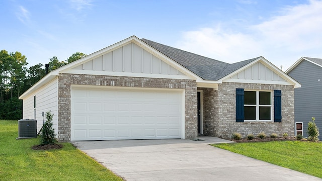 view of front facade with a front lawn, a garage, and cooling unit