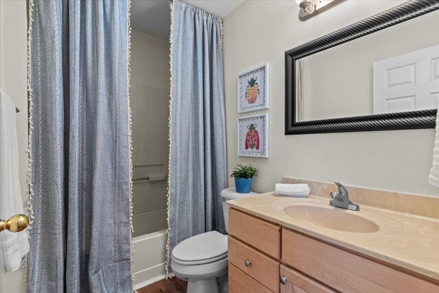 493 Shiloh Rd, Hartford, AL 36344 - full bath featuring vanity, shower / bath combination with curtain, and wood finished floors