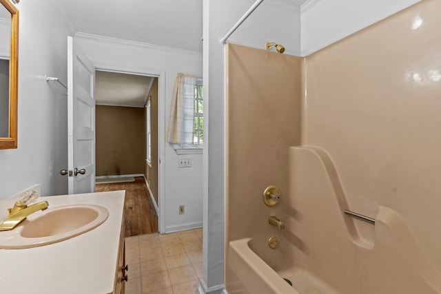 bathroom featuring crown molding, shower / bathtub combination, tile patterned flooring, vanity, and baseboards
