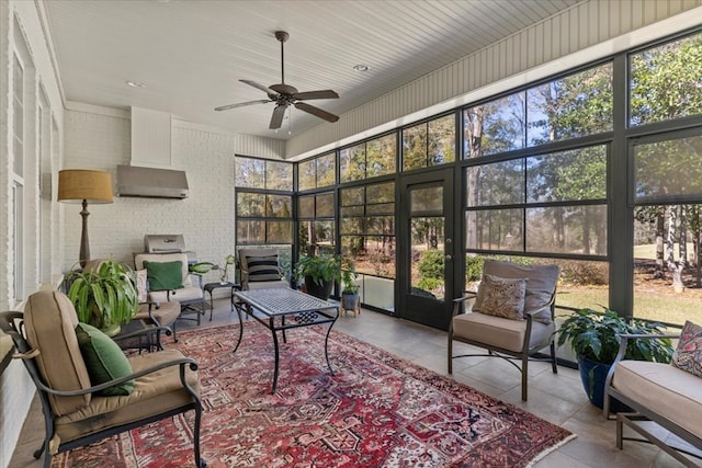 sunroom / solarium featuring plenty of natural light and a ceiling fan