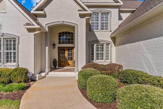 entrance to property featuring brick siding