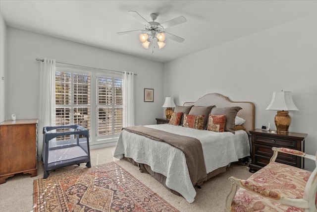 bedroom with light carpet and a ceiling fan