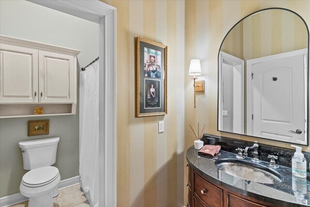 bathroom featuring wallpapered walls, baseboards, toilet, tile patterned flooring, and vanity