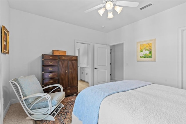 bedroom featuring visible vents, ceiling fan, baseboards, and ensuite bathroom