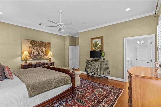 bedroom featuring recessed lighting, wood finished floors, visible vents, baseboards, and crown molding