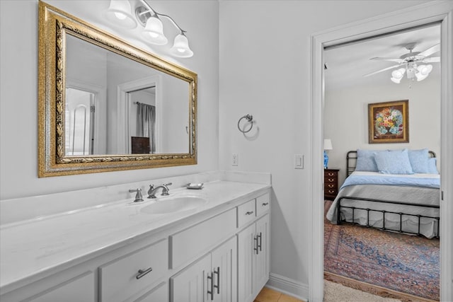 ensuite bathroom with baseboards, connected bathroom, a ceiling fan, tile patterned floors, and vanity