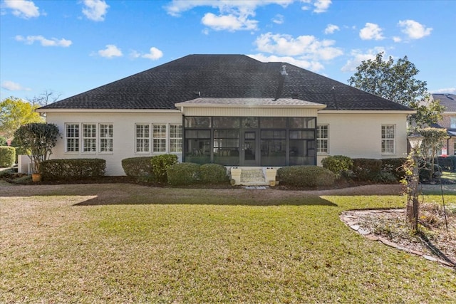 rear view of property with a sunroom and a yard