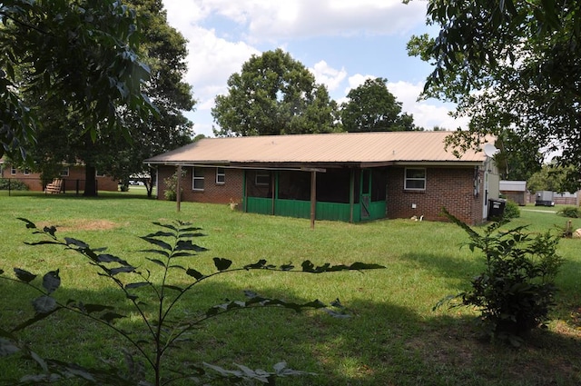 rear view of house with a lawn