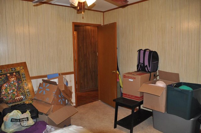 carpeted office with ceiling fan and crown molding