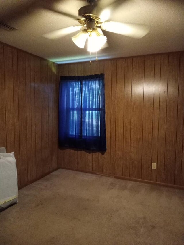 210 Anderson St, Kinston, AL 36453 - misc room with wooden walls, carpet, and a ceiling fan
