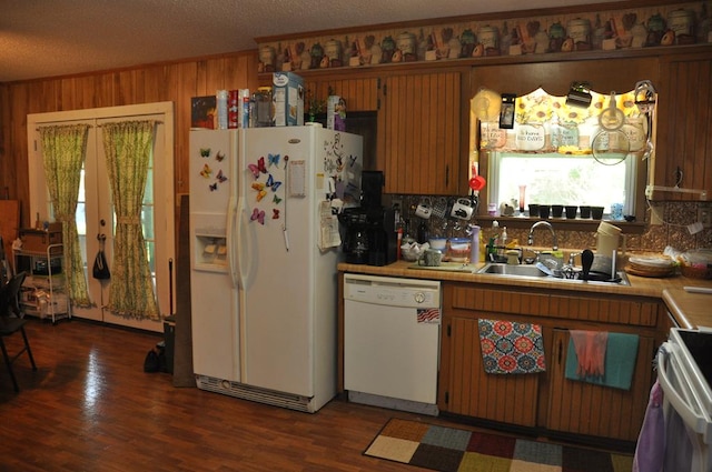 kitchen featuring a textured ceiling, dark hardwood / wood-style floors, white appliances, and sink