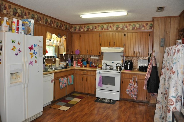 kitchen with a textured ceiling, white appliances, dark wood-type flooring, and sink