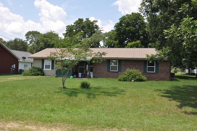 210 Anderson St, Kinston, AL 36453 - single story home featuring a front yard, a metal roof, and brick siding