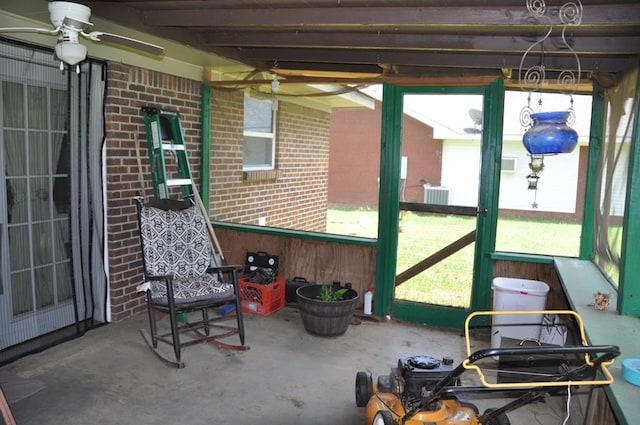 sunroom featuring ceiling fan