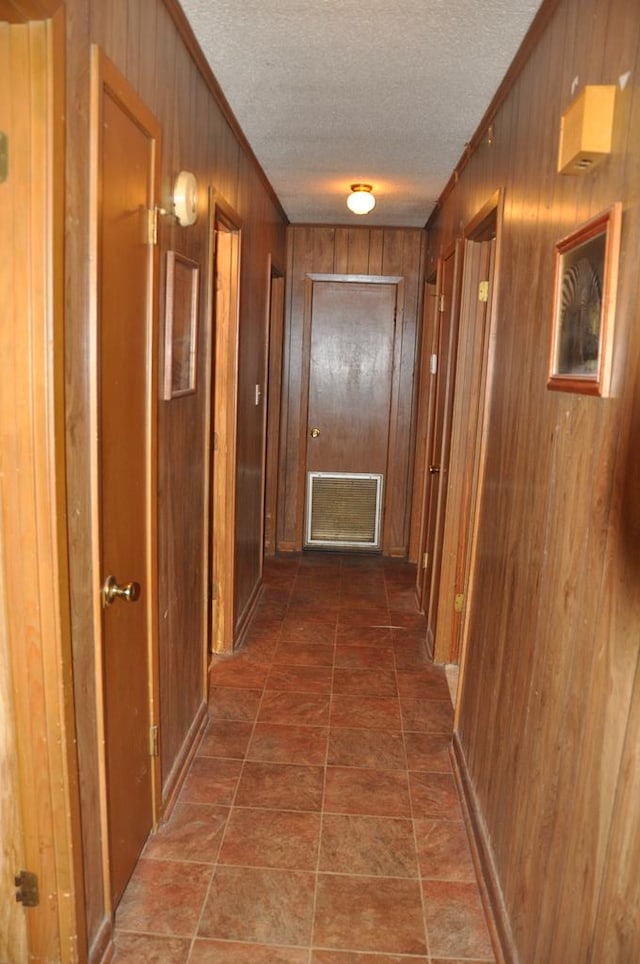 210 Anderson St, Kinston, AL 36453 - corridor with wood walls, a textured ceiling, and crown molding