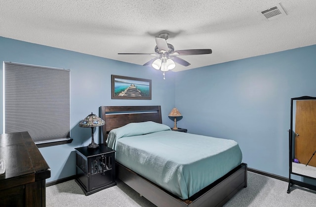 bedroom with visible vents, light carpet, ceiling fan, a textured ceiling, and baseboards