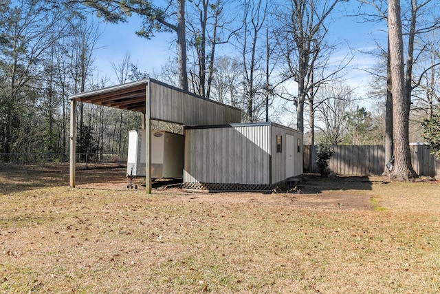 view of outbuilding with an outdoor structure and fence